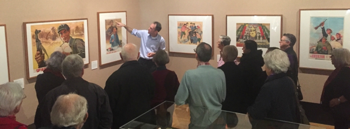 Curator Nathan Woolley conducts a tour of the 'Waving the Red Flag' exhibition