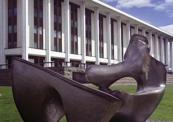 Reclining figure sculpture situated outside the Library building