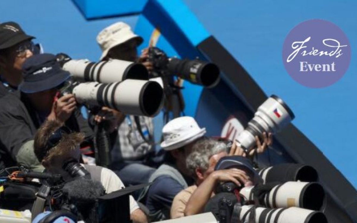 Image features media photographers crowded together with long lenses