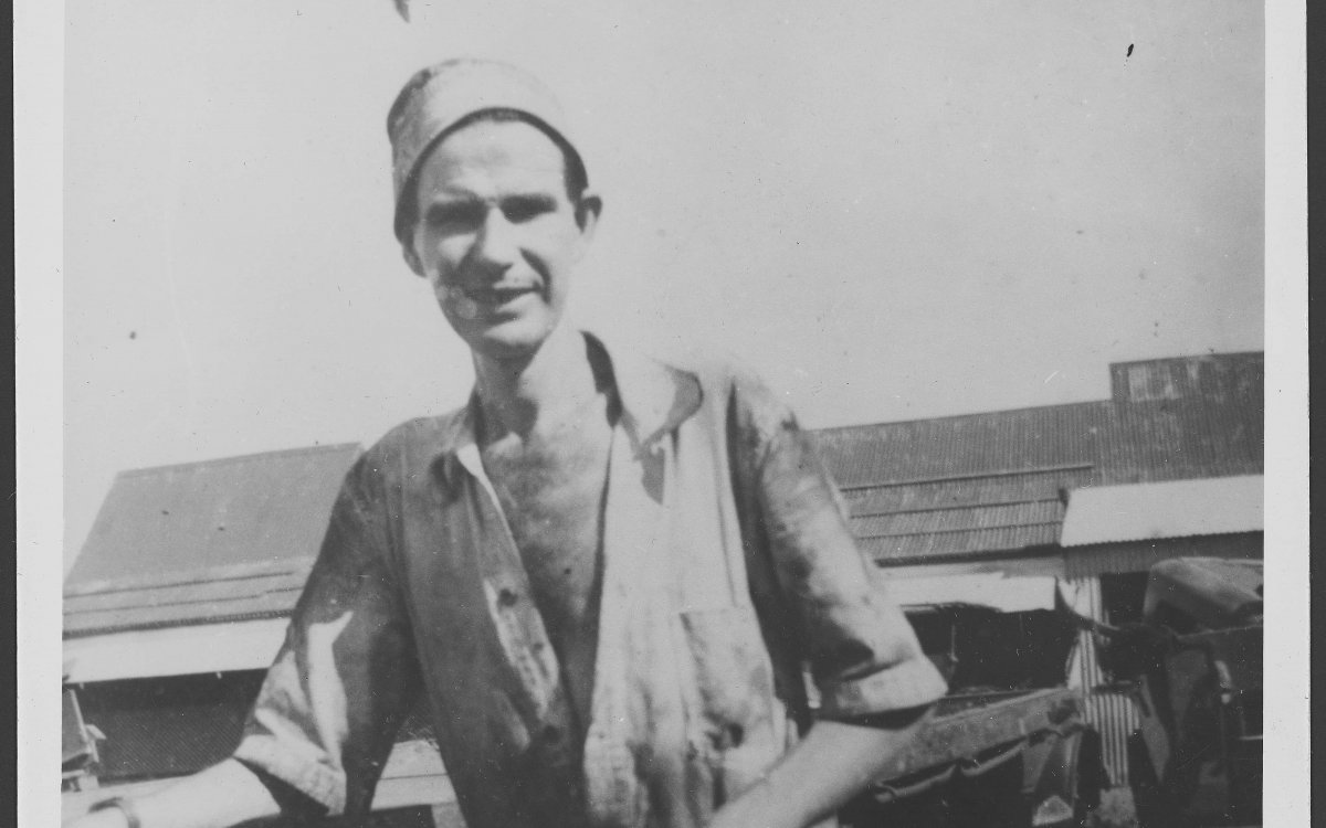 black and white photograph of a man holding an empty bag