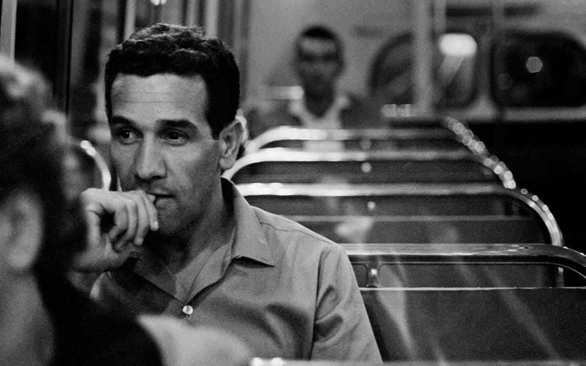 black and white photo of young man on bus