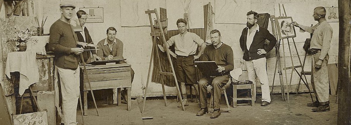 Seven men painting in art studio