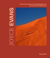 Book cover for Joyce Evans by Sasha Grishin. A red background with a  off centre close up photograph of Uluru and a slice of sky just off. The text on the cover reads ''I don't know what sort of photographer I am, but I try to be an honest one. Joyce Evans. Sasha Grishin.'