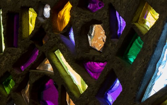 Stained glass in purple, green, pink, orange, red and yellow chunks