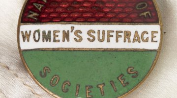 A round painted coin reads "women's suffrage societies'