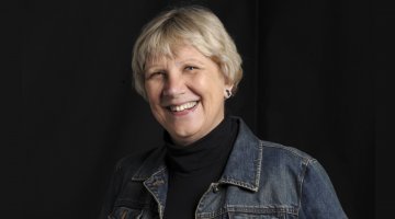 Headshot of author Jaqueline Kent on a black background