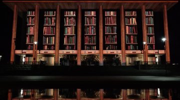 Enlighten illumination showing bookshelves on National Library building