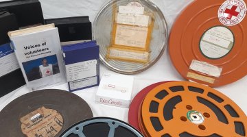 A selection of Australian Red Cross Society films in circular and rectangular cases.