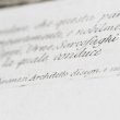 A close up image of calligraphy print on a page. Only full word in focus is 'Architetto'