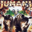 A section of the movie poster for the 1995 film Jumanji showing 2 rhinos, and elephant and 2 dice exploding out of a boardgame.