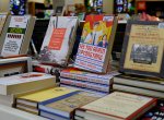 A brightly coloured book display featuring hardcover books propped up with their covers facing the camera