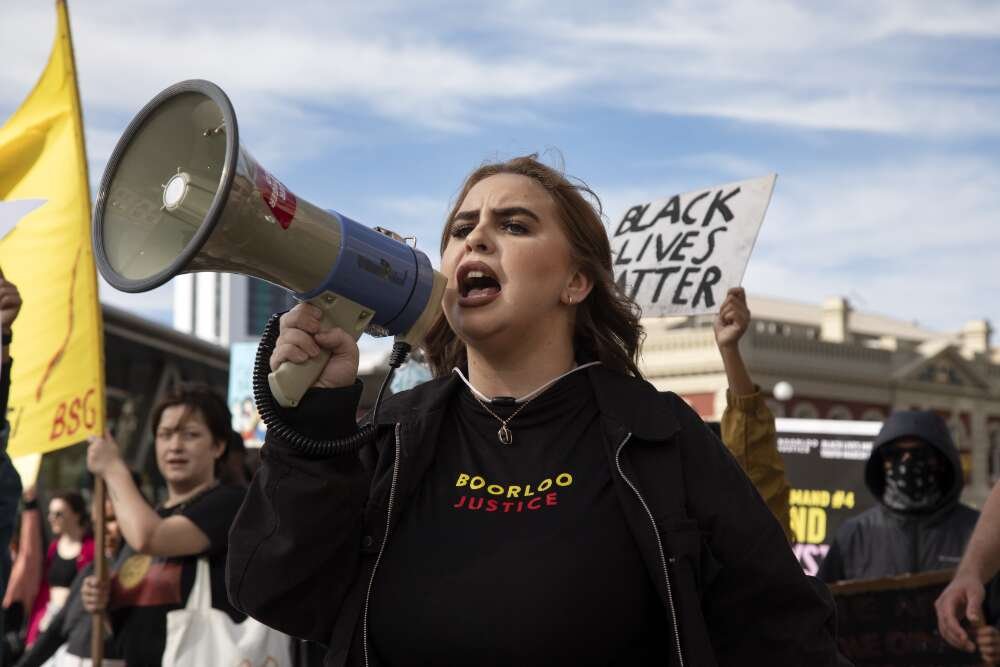 Protester Tanesha Bennell holding a megaphone at the Black Lives Matter protest rally, Perth, Western Australia, 2020 