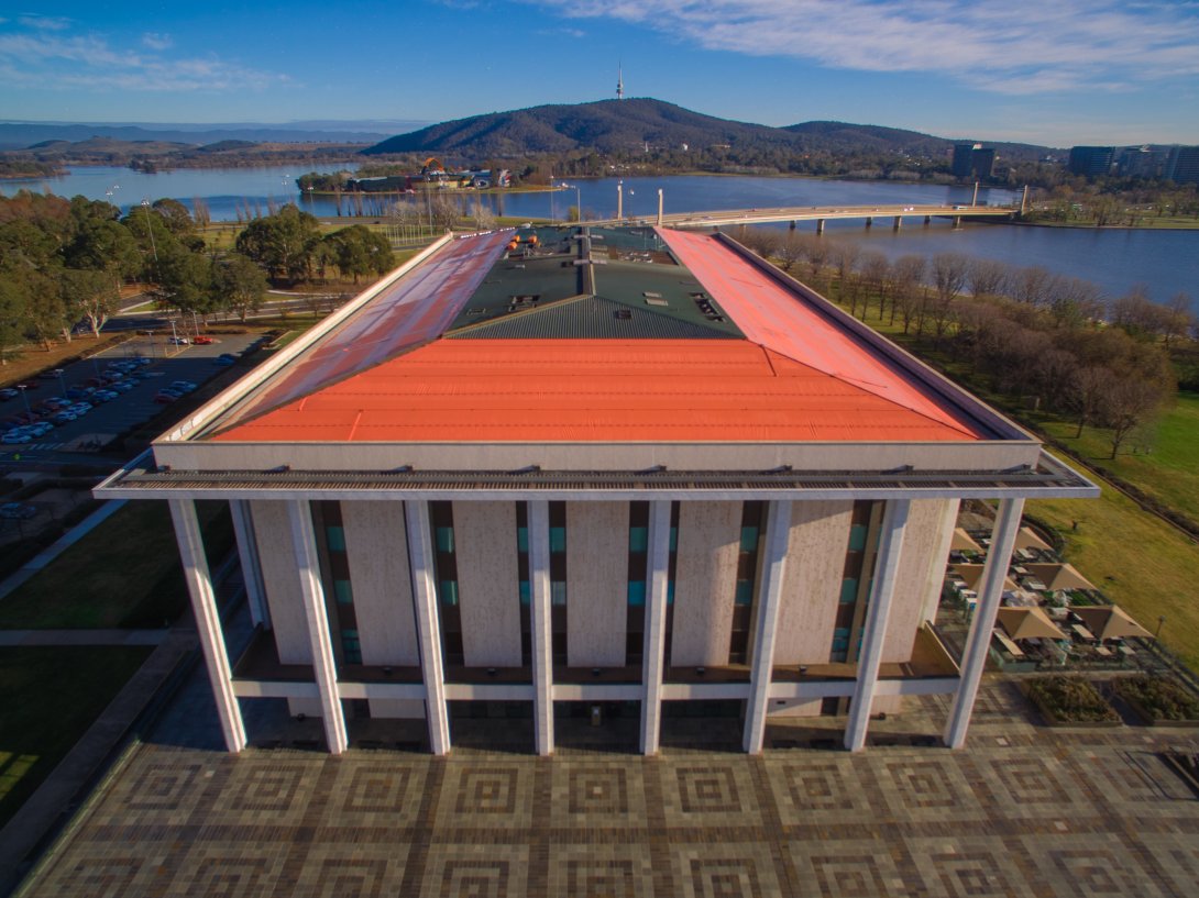 An aerial view of the National Library building featuring an angled orange roof