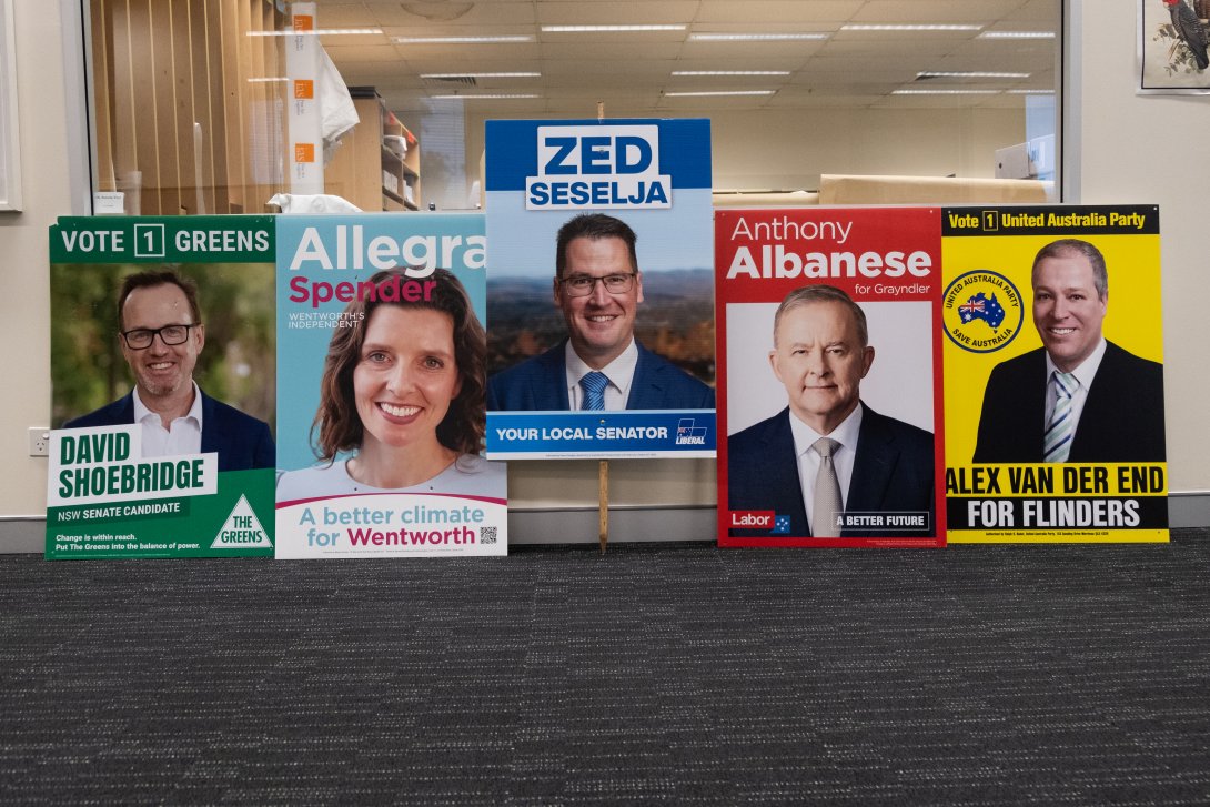 Bright election posters feature a variety of candidates on different coloured backgrounds