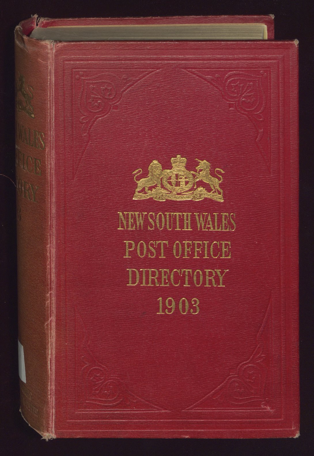 Old book with red leather cover with gold emblem and gold text reading 'NEW SOUTH WALES POST OFFICE DIRECTORY 1918'