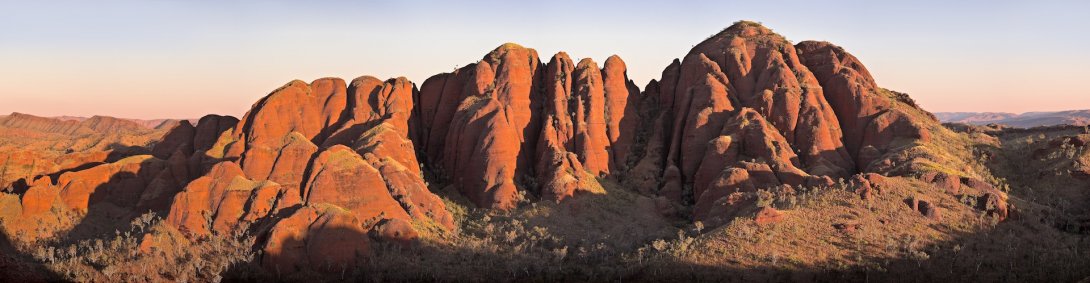 Large red rock formation at sunrise or sunset