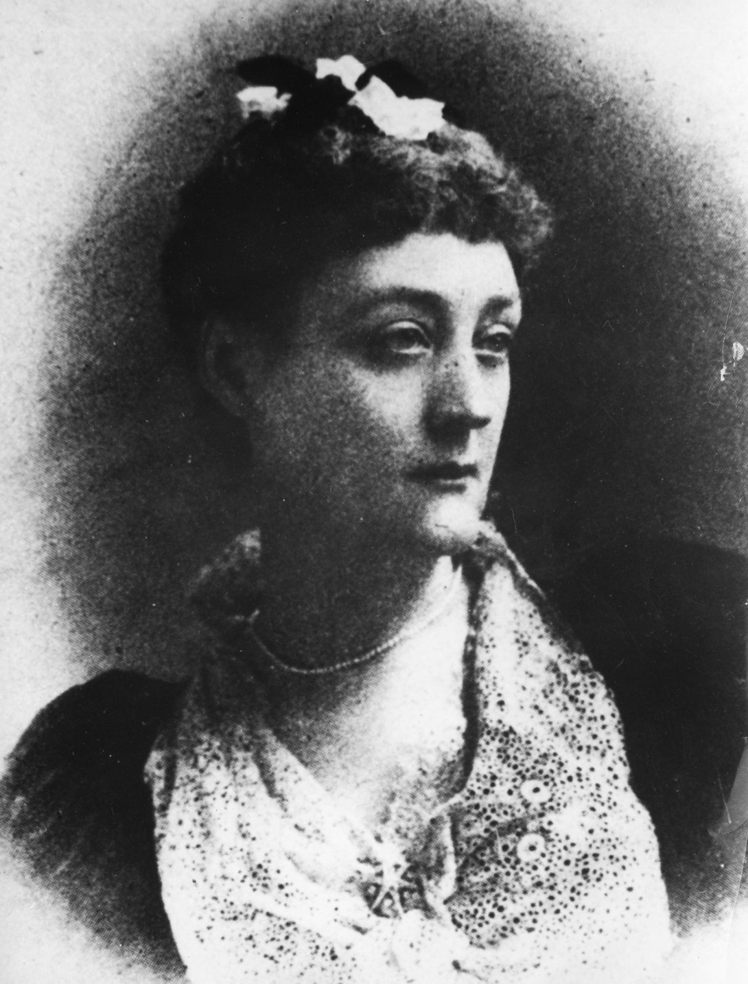 Photo portrait of Rosa Praed, wearing formal closes and looking to her right with a serious face